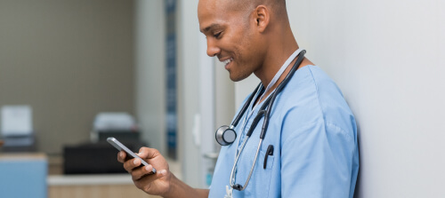 Healthcare professional reviewing patient information on a smartphone